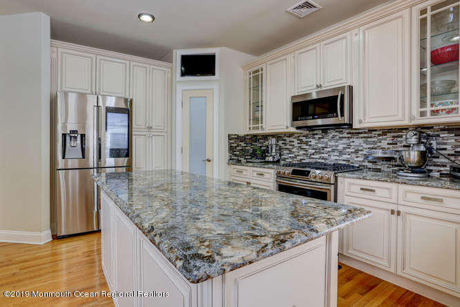58 Fort Plains Road Howell, NJ 07731 - Photo 7 of 33 a kitchen with stainless steel appliances granite countertop a sink stove and refrigerator