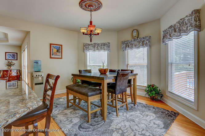 58 Fort Plains Road Howell, NJ 07731 - Photo 9 of 33 a dining room with furniture a rug a potted plant and a rug