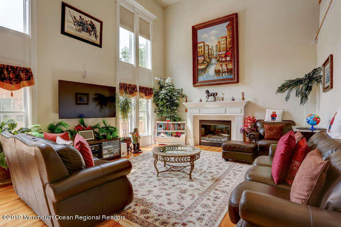 58 Fort Plains Road Howell, NJ 07731 - Photo 10 of 33 a living room with furniture a fireplace and a flat screen tv