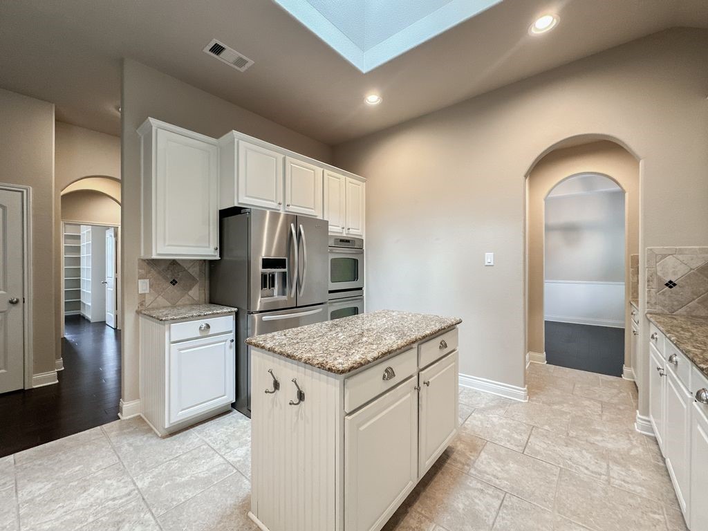 10 Pilot Rock Place Tomball, TX 77375 - Photo 11 of 38 a kitchen with stainless steel appliances granite countertop a refrigerator a sink and white cabinets