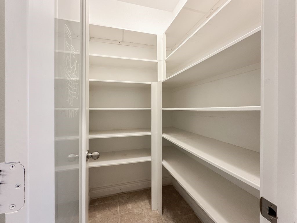 10 Pilot Rock Place Tomball, TX 77375 - Photo 13 of 38 a view of walk in closet with empty racks