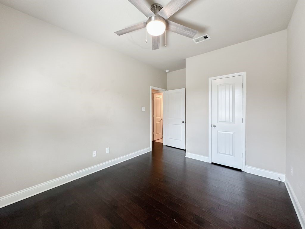 10 Pilot Rock Place Tomball, TX 77375 - Photo 20 of 38 an empty room with wooden floor and windows