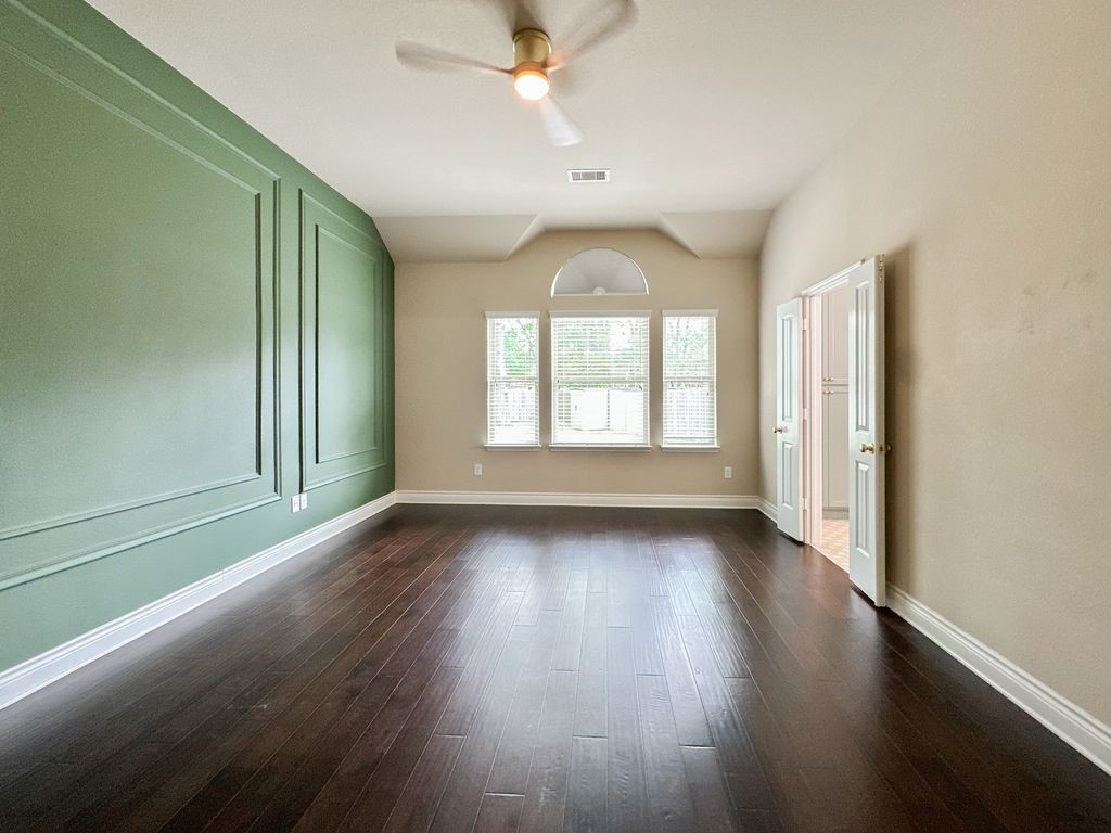 10 Pilot Rock Place Tomball, TX 77375 - Photo 28 of 38 an empty room with wooden floor fan and windows