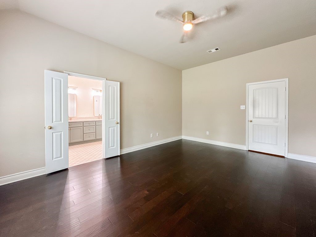 10 Pilot Rock Place Tomball, TX 77375 - Photo 29 of 38 a view of an empty room with wooden floor and a window