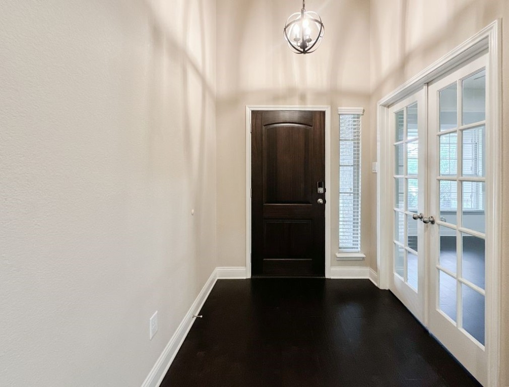10 Pilot Rock Place Tomball, TX 77375 - Photo 3 of 38 a view of a hallway with wooden floor and staircase