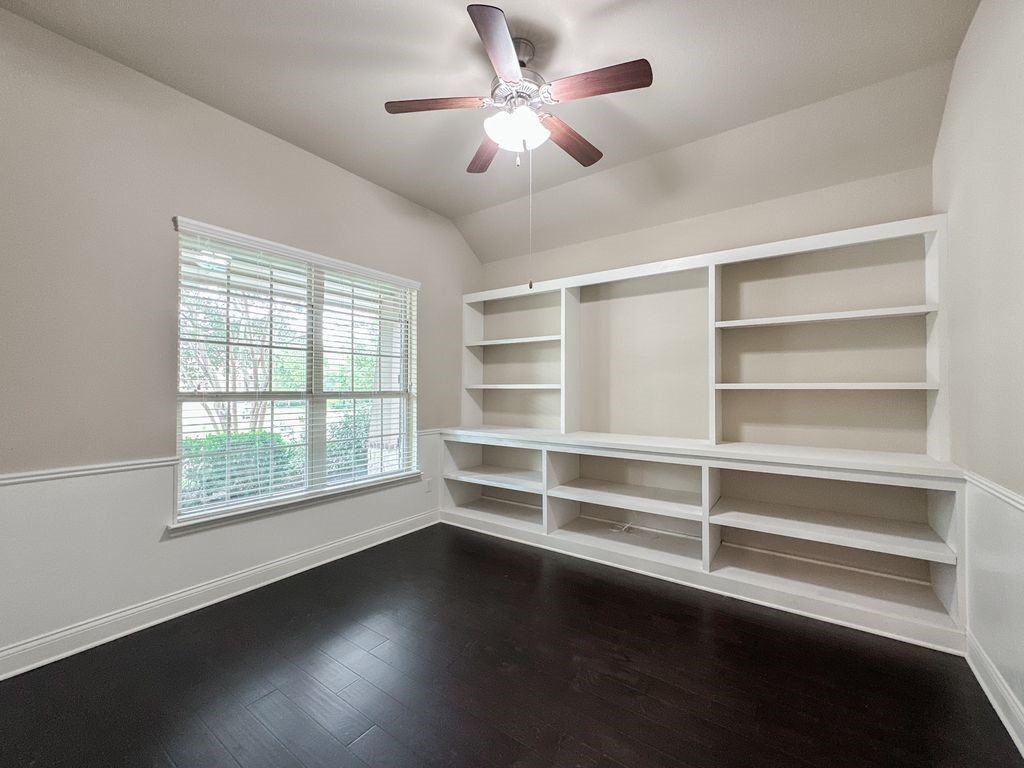 10 Pilot Rock Place Tomball, TX 77375 - Photo 4 of 38 a view of an empty room with a window and wooden floor