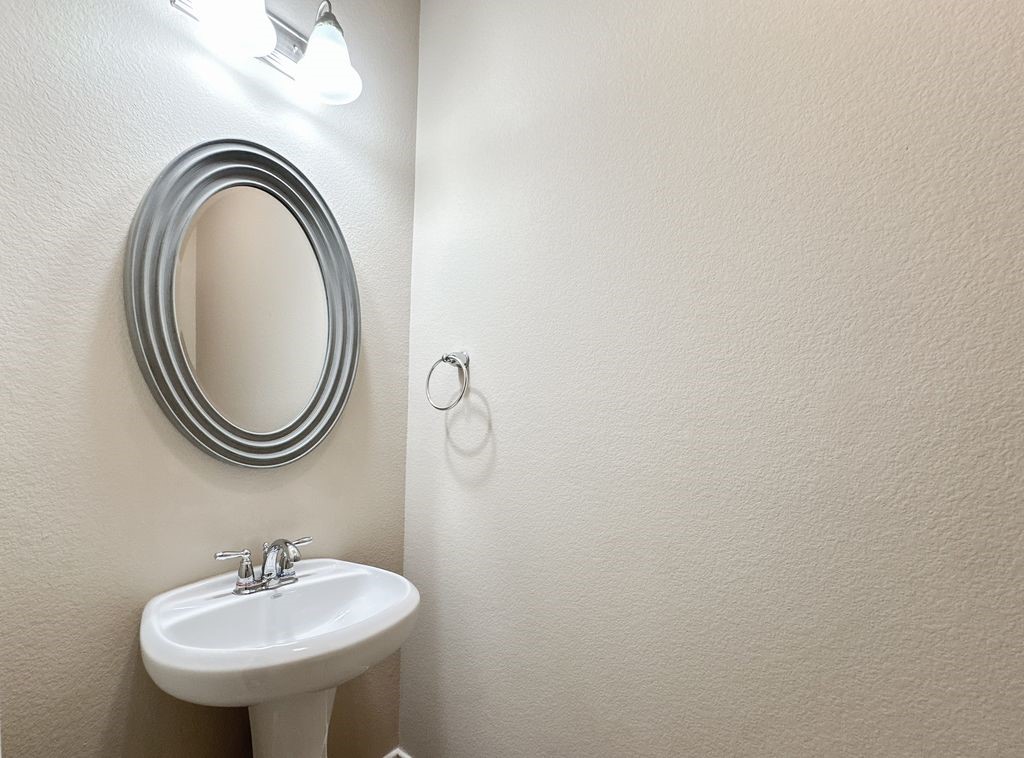 10 Pilot Rock Place Tomball, TX 77375 - Photo 8 of 38 a bathroom with a sink and a mirror
