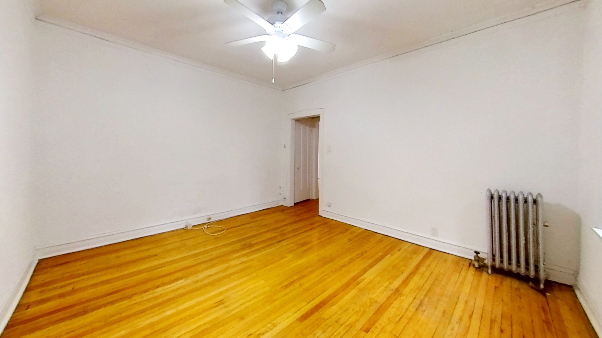 1337 West Addison Street, Unit 1A Chicago, IL 60613 - Photo 3 of 9 a view of empty room with wooden floor