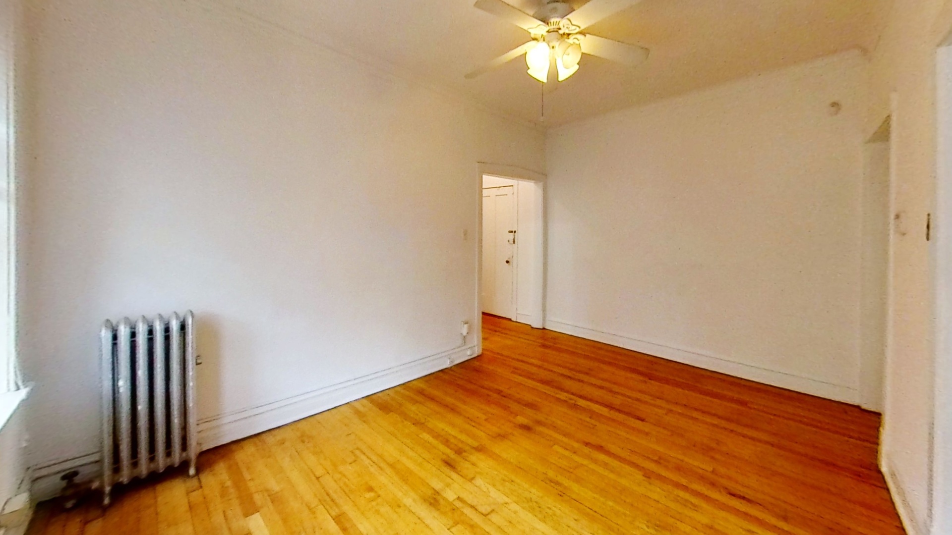 1337 West Addison Street, Unit 1A Chicago, IL 60613 - Photo 4 of 9 a view of empty room with wooden floor