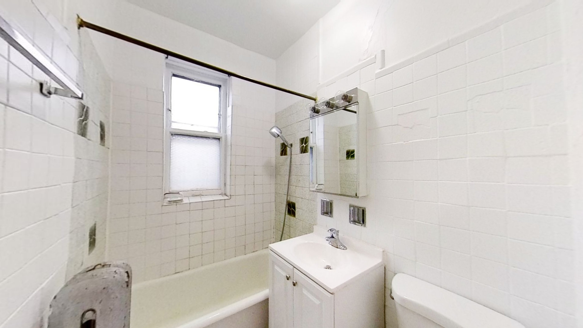 1337 West Addison Street, Unit 1A Chicago, IL 60613 - Photo 8 of 9 a bathroom with a sink a toilet and shower