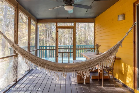 a view of a balcony with wooden floor and furniture