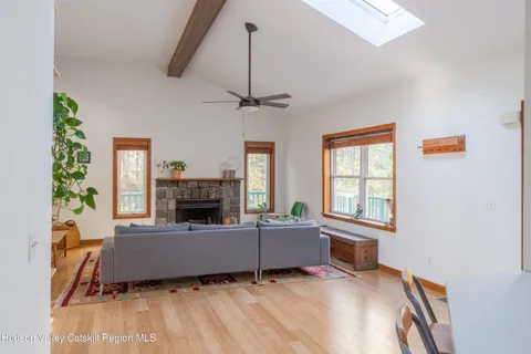 a living room with furniture a fireplace and a window