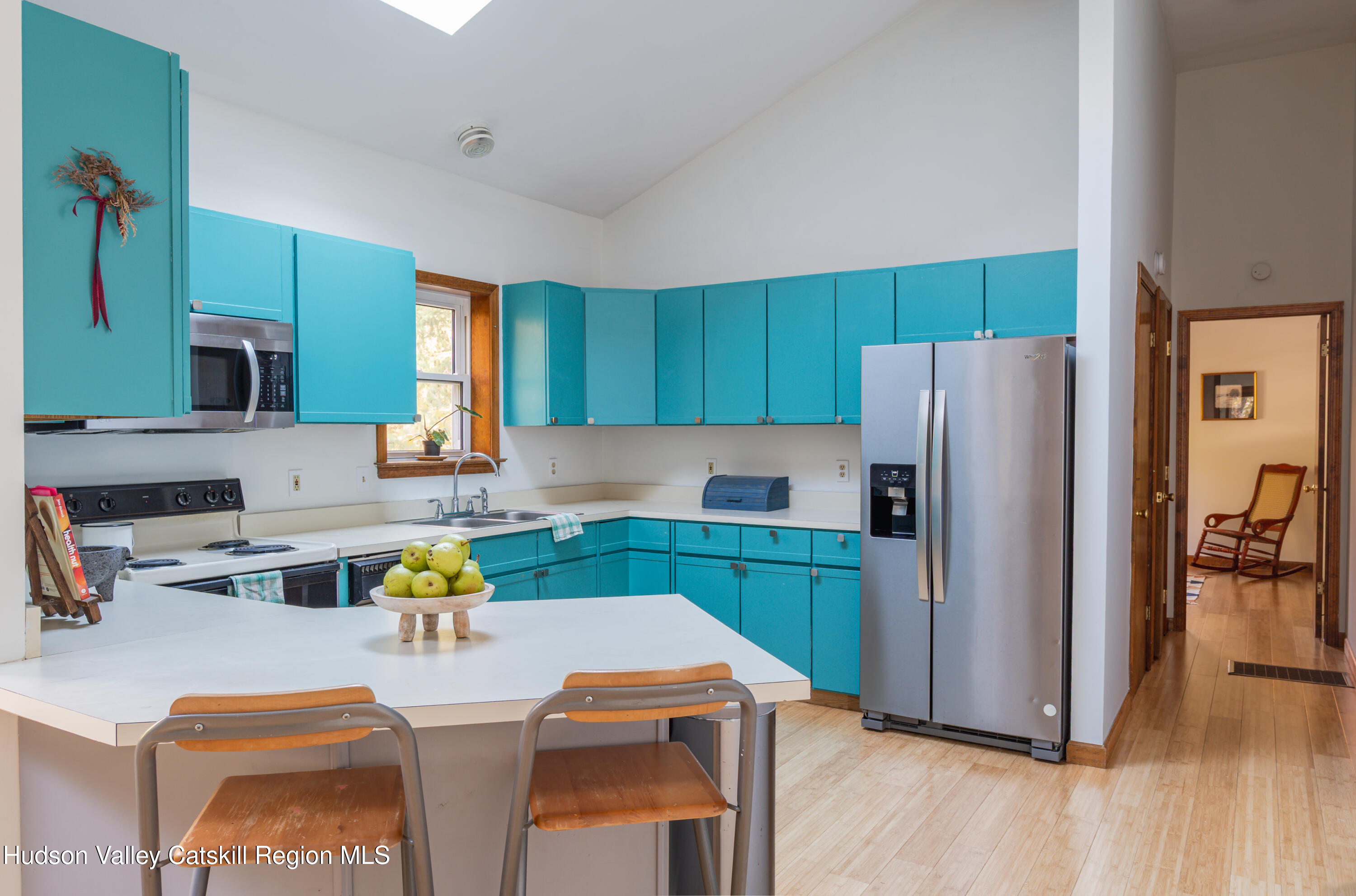 12 Glow Court Athens, NY 12015 - Photo 5 of 22 a kitchen with a refrigerator a stove a sink cabinets and a dining table