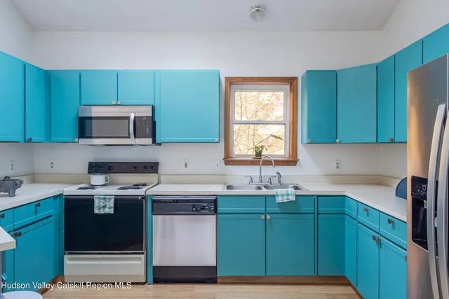a kitchen with a sink a microwave and cabinets