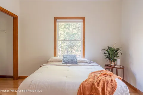 a bedroom with a bed and a potted plant