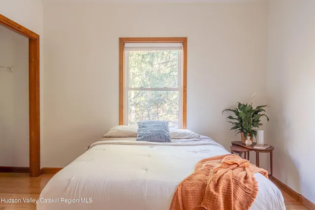 a bedroom with a bed and a potted plant