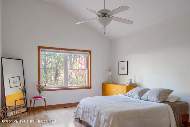 a bedroom with a bed a chandelier and a window