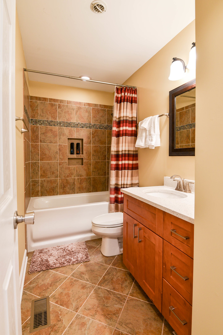 44 Forestview Lane Aurora, IL 60502 - Photo 11 of 18 a bathroom with a sink toilet and shower