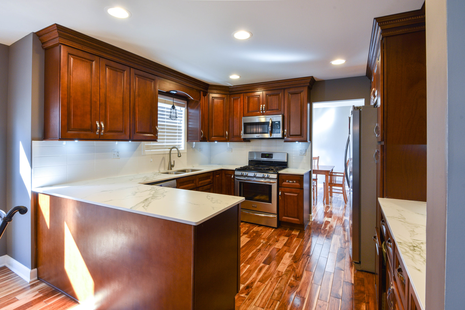 44 Forestview Lane Aurora, IL 60502 - Photo 4 of 18 a kitchen with stainless steel appliances granite countertop a refrigerator a stove top oven a sink dishwasher and wooden cabinets with wooden floor