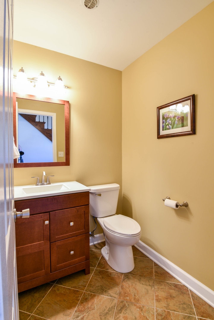 44 Forestview Lane Aurora, IL 60502 - Photo 8 of 18 a bathroom with a toilet sink and mirror