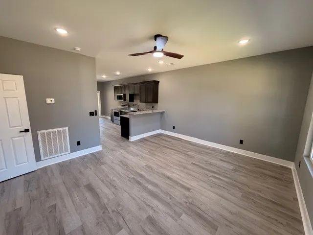 a view of kitchen with sink and microwave
