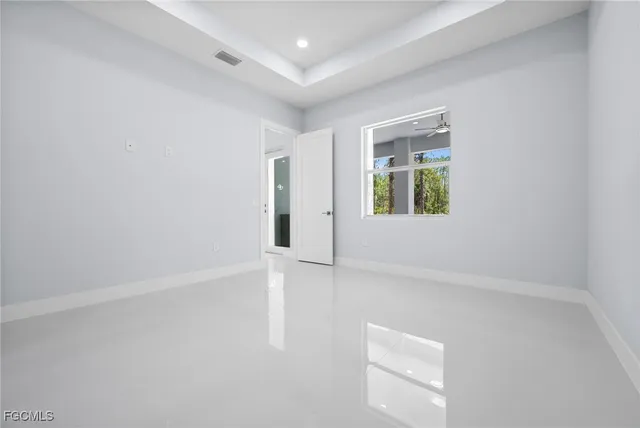 a bedroom with bed and a potted plant