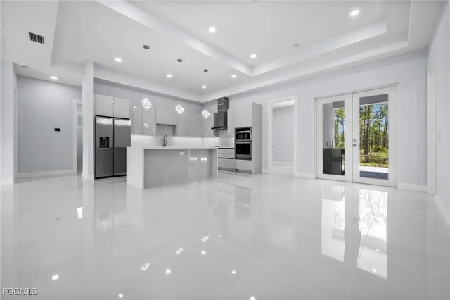 a view of a kitchen with refrigerator and windows
