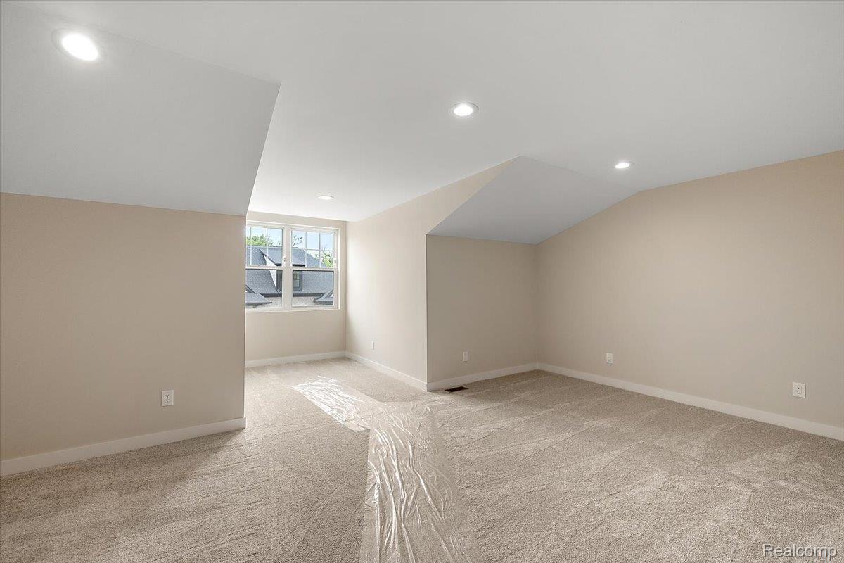 2032 Breckenridge Court, Unit 9 Rochester, MI 48309 - Photo 33 of 39 Bonus room featuring recessed lighting, light carpet, and vaulted ceiling