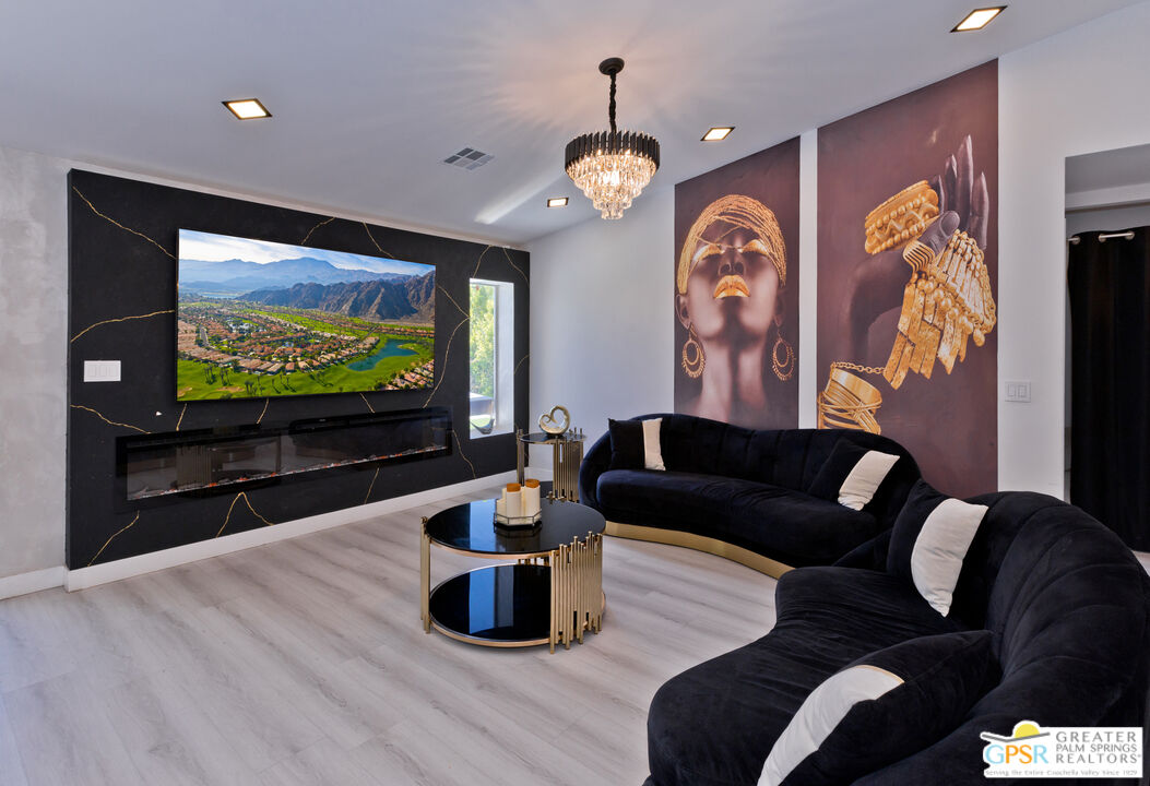 12800 Miracle Hill Road Desert Hot Springs, CA 92240 - Photo 11 of 51 a living room with furniture and a flat screen tv