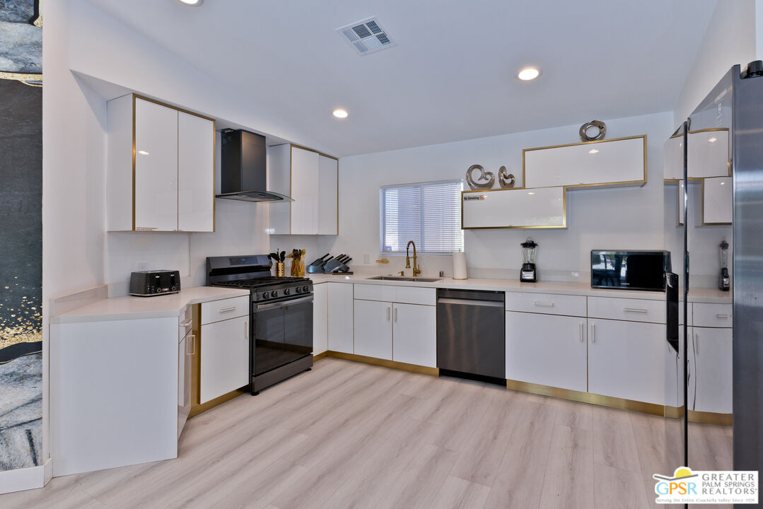 12800 Miracle Hill Road Desert Hot Springs, CA 92240 - Photo 19 of 51 a kitchen with a white cabinets and white appliances