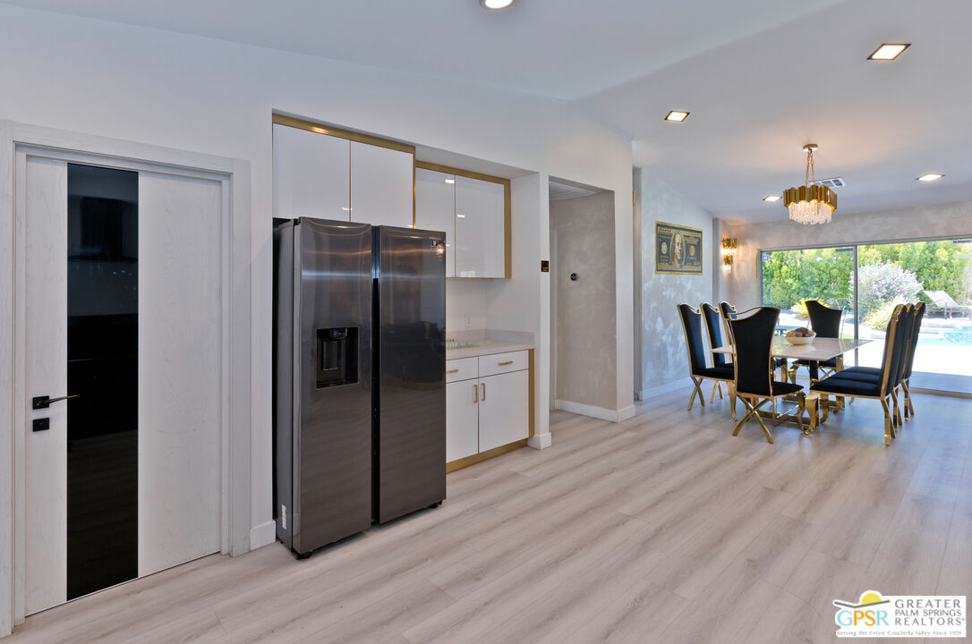 12800 Miracle Hill Road Desert Hot Springs, CA 92240 - Photo 20 of 51 a kitchen with stainless steel appliances granite countertop a refrigerator and a dining table