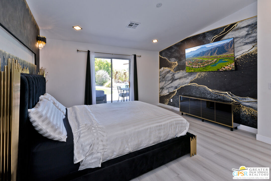 12800 Miracle Hill Road Desert Hot Springs, CA 92240 - Photo 25 of 51 a bed room with a bed and a television