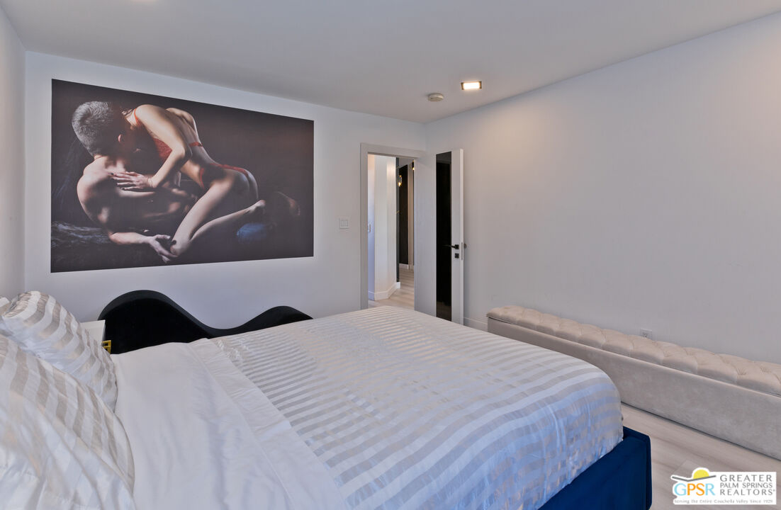 12800 Miracle Hill Road Desert Hot Springs, CA 92240 - Photo 33 of 51 a bedroom with a bed and wall painting