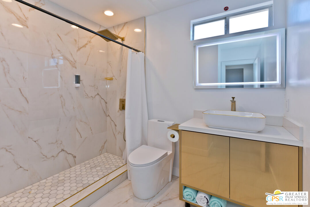 12800 Miracle Hill Road Desert Hot Springs, CA 92240 - Photo 35 of 51 a bathroom with a sink a toilet and shower