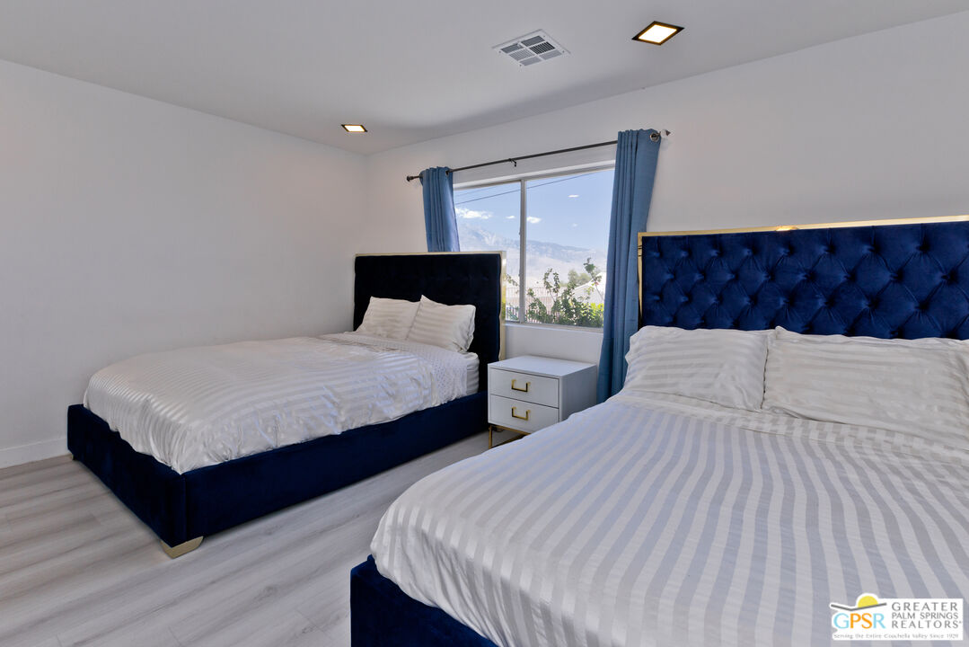 12800 Miracle Hill Road Desert Hot Springs, CA 92240 - Photo 36 of 51 a bedroom with two beds and a night stand