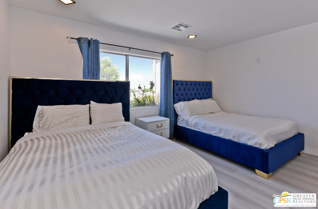 12800 Miracle Hill Road Desert Hot Springs, CA 92240 - Photo 37 of 51 a bedroom with double bed and a night stand