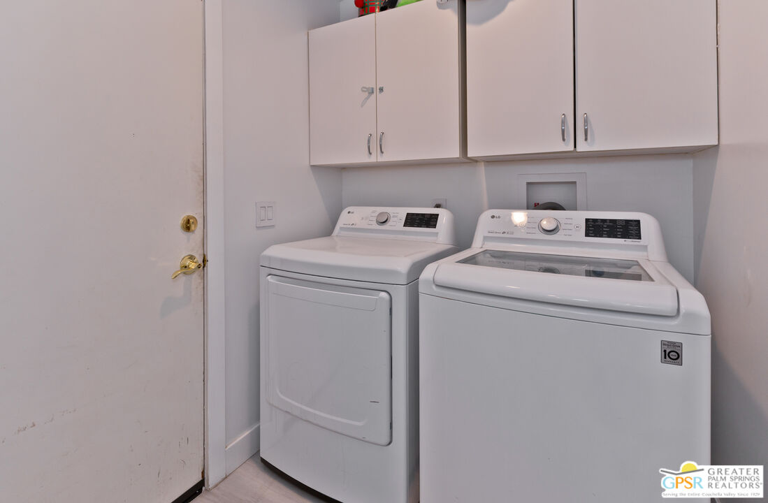 12800 Miracle Hill Road Desert Hot Springs, CA 92240 - Photo 39 of 51 a view of washer and dryer with kitchen appliances