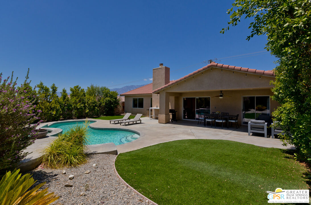 12800 Miracle Hill Road Desert Hot Springs, CA 92240 - Photo 4 of 51 a front view of a house with swimming pool having outdoor seating
