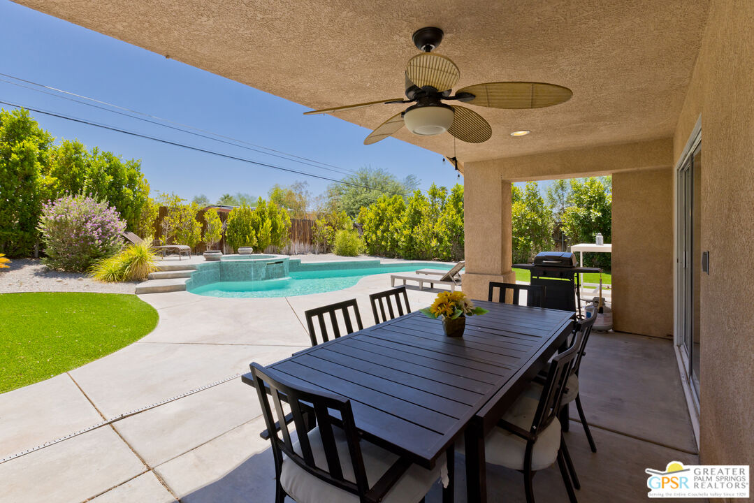 12800 Miracle Hill Road Desert Hot Springs, CA 92240 - Photo 43 of 51 a view of a patio with a table chairs and a backyard