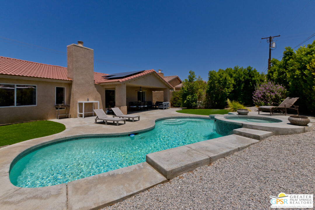 12800 Miracle Hill Road Desert Hot Springs, CA 92240 - Photo 44 of 51 a front view of a house with garden and trees