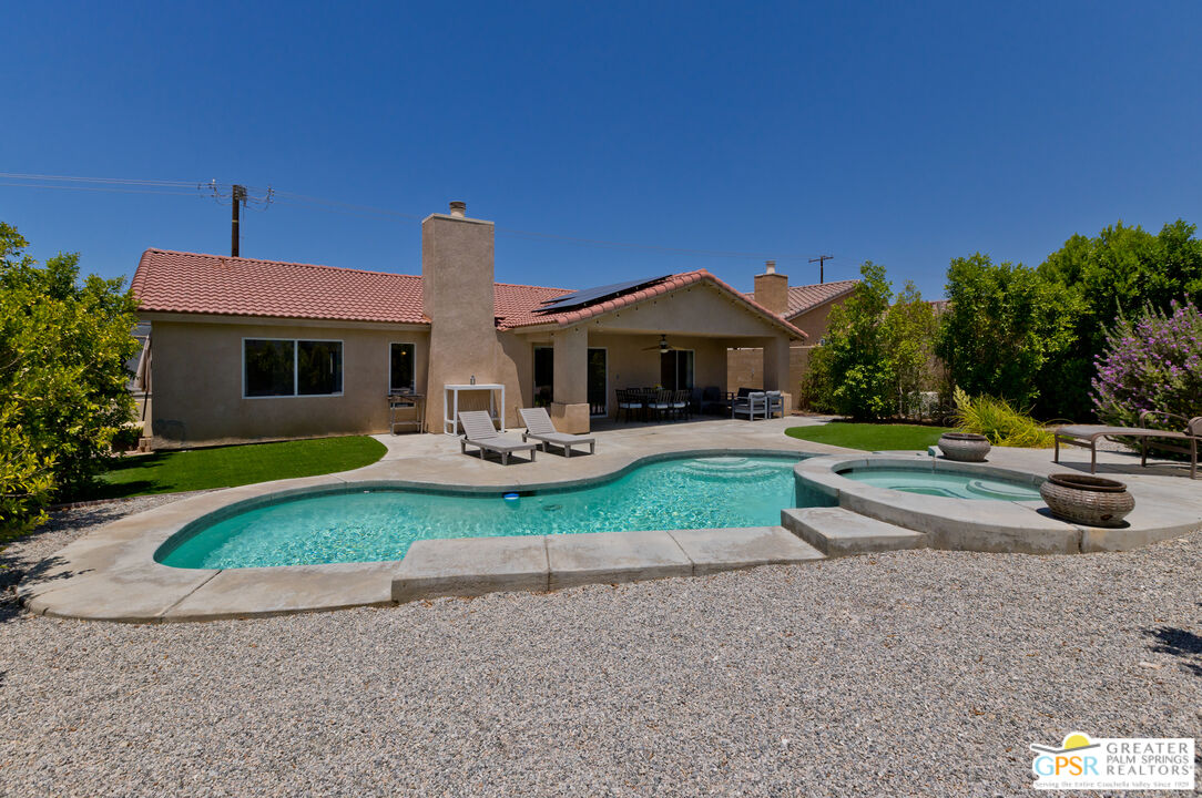 12800 Miracle Hill Road Desert Hot Springs, CA 92240 - Photo 5 of 51 a view of a house with a yard patio and fire pit