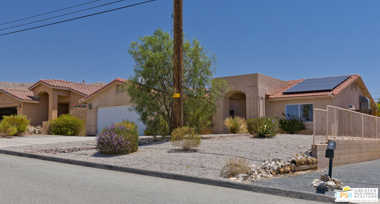 12800 Miracle Hill Road Desert Hot Springs, CA 92240 - Photo 8 of 51 a front view of a house with a yard