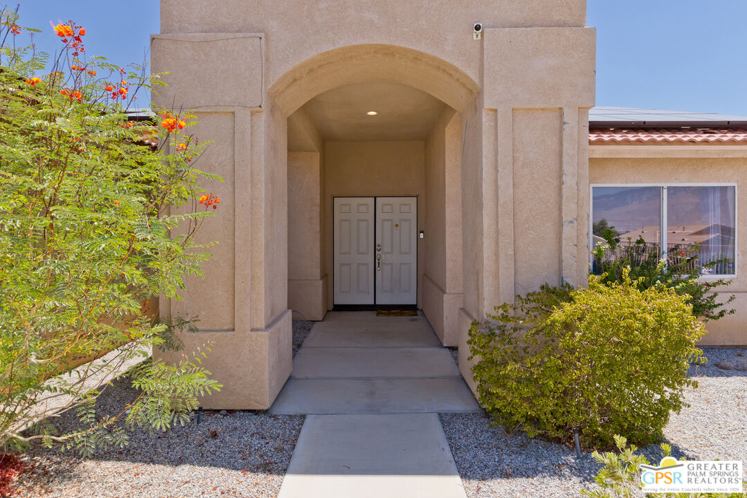 12800 Miracle Hill Road Desert Hot Springs, CA 92240 - Photo 9 of 51 a view of entryway with flower pots