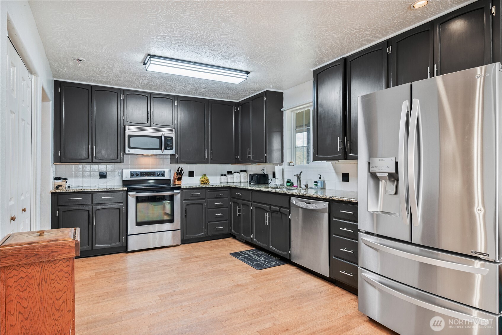 4514 Ohio Street Longview, WA 98632 - Photo 4 of 30 a kitchen with stainless steel appliances granite countertop a refrigerator stove and sink