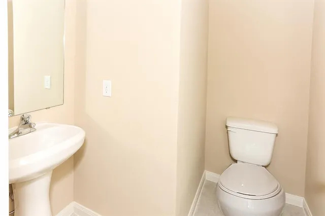 a white toilet sitting next to a bathroom sink