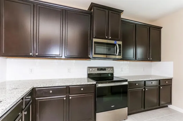 a kitchen with a sink and steel appliances
