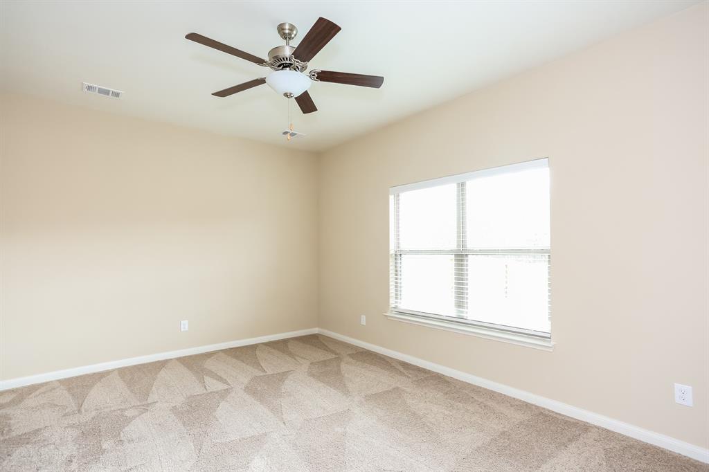 1421 Park Trails Boulevard Princeton, TX 75407 - Photo 7 of 17 an empty room with a window and a fan