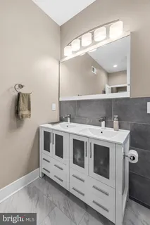 a view of a bathroom with a sink and mirror