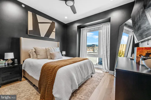 a bedroom with a large bed and a flat tv screen on a dresser