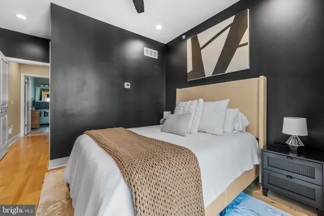 a bedroom with a large bed and a chandelier